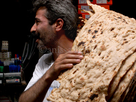 iran-man carrying bread thru bazar copy